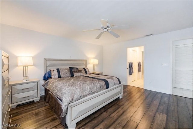 bedroom featuring a ceiling fan, visible vents, dark wood finished floors, and baseboards