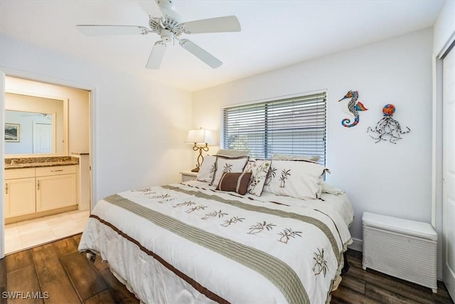 bedroom featuring a ceiling fan, dark wood-style flooring, and ensuite bathroom