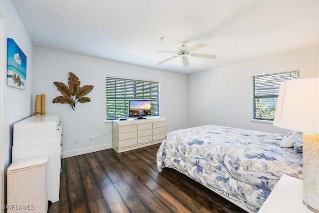 bedroom featuring dark wood-style floors, ceiling fan, and baseboards