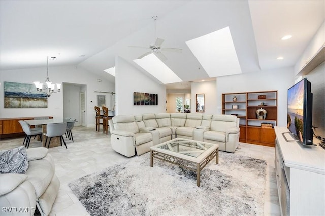 living area with high vaulted ceiling, a skylight, recessed lighting, and ceiling fan with notable chandelier