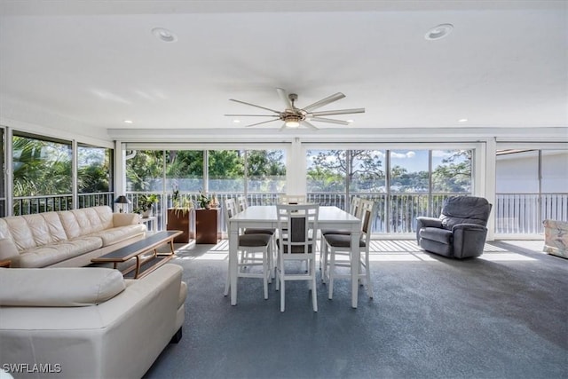 sunroom / solarium with a ceiling fan