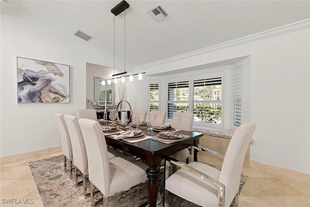 dining space featuring crown molding, baseboards, visible vents, and vaulted ceiling