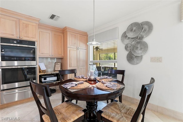 dining area featuring visible vents, baseboards, light tile patterned flooring, and crown molding