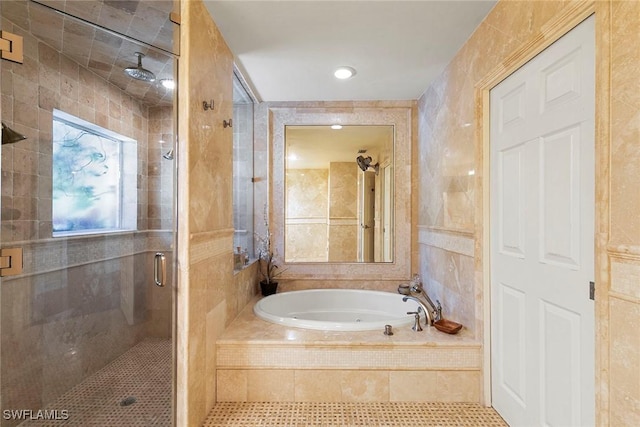 full bathroom featuring tile walls, a bath, a stall shower, and tile patterned floors