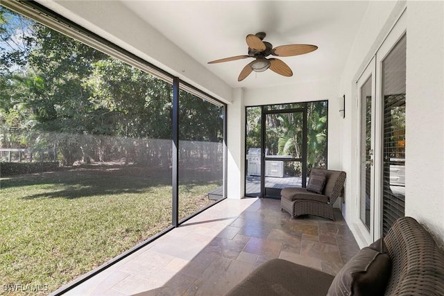 sunroom featuring a ceiling fan