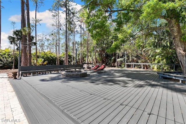 wooden terrace featuring an outdoor fire pit