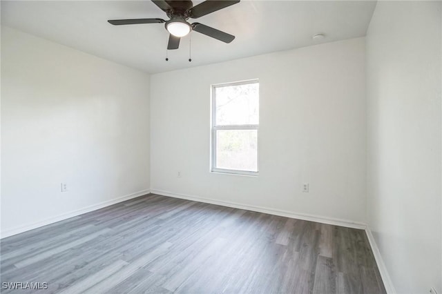 empty room with hardwood / wood-style flooring and ceiling fan