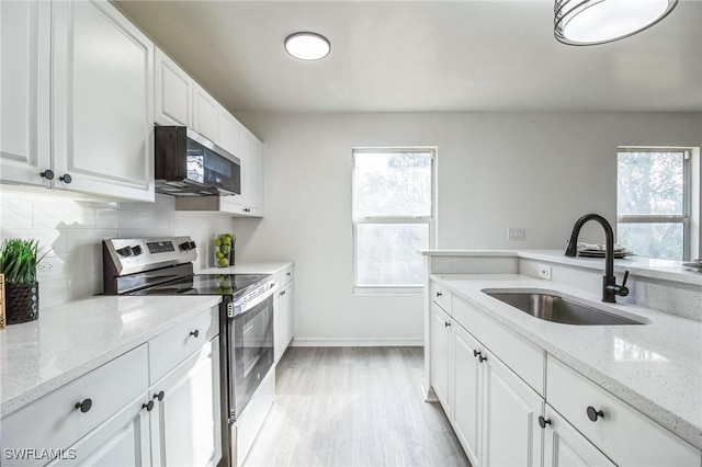 kitchen featuring sink, stainless steel appliances, white cabinets, and light stone countertops