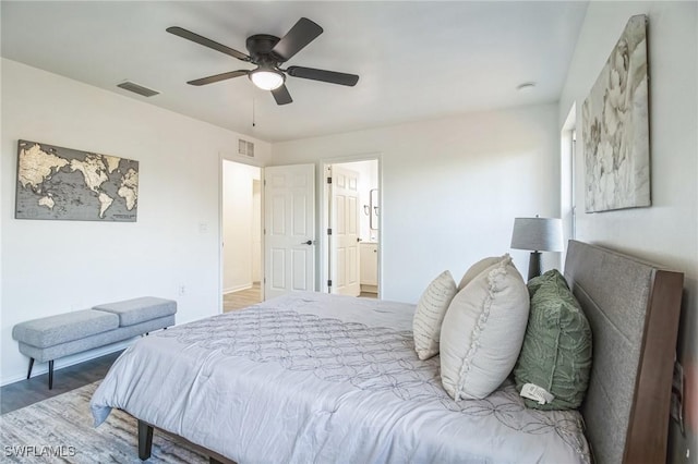 bedroom featuring hardwood / wood-style flooring, ceiling fan, and ensuite bathroom