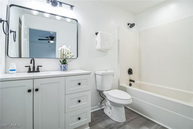 full bathroom with shower / bathing tub combination, hardwood / wood-style floors, vanity, and toilet