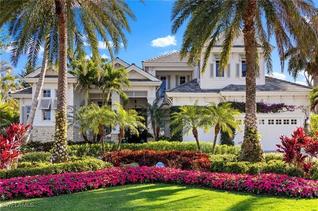 view of front facade with a garage and a front lawn