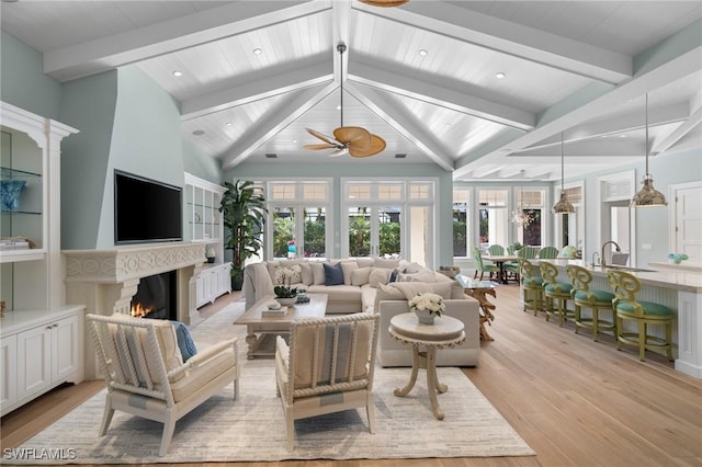 532 Pine Grove Ln, Naples, FL 34103 - living area with beamed ceiling, a warm lit fireplace, light wood-style flooring, ceiling fan, and recessed lighting