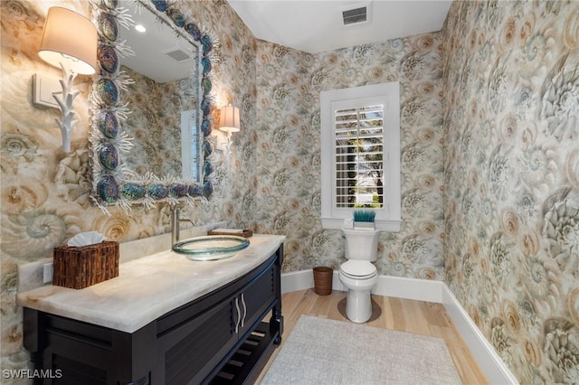 532 Pine Grove Ln, Naples, FL 34103 - bathroom featuring vanity, toilet, baseboards, wood finished floors, and visible vents