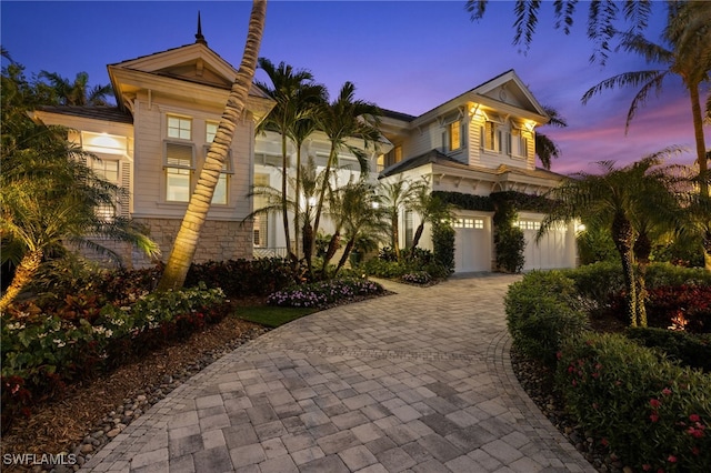 532 Pine Grove Ln, Naples, FL 34103 - mediterranean / spanish house with decorative driveway, stone siding, and a garage