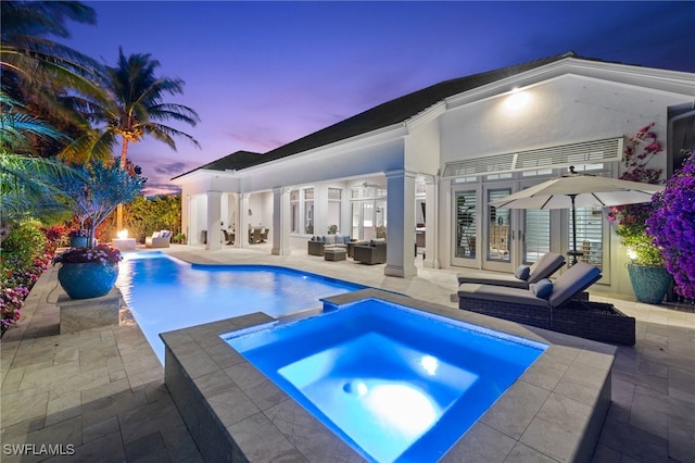 532 Pine Grove Ln, Naples, FL 34103 - pool at dusk featuring an outdoor hangout area, a patio area, french doors, and a pool with connected hot tub