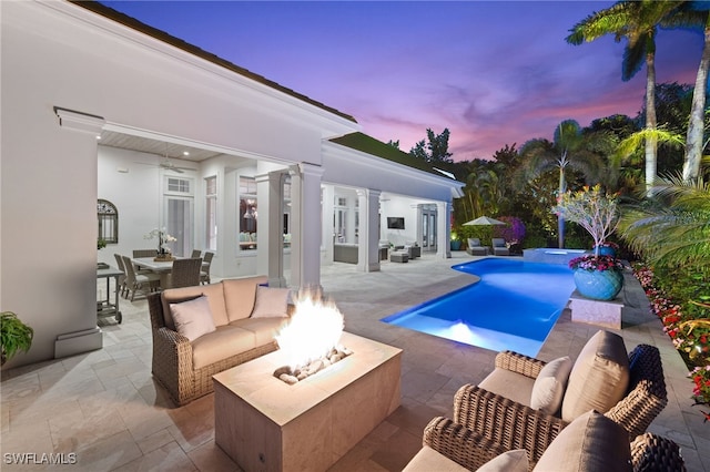 532 Pine Grove Ln, Naples, FL 34103 - pool at dusk featuring a patio area, an outdoor living space with a fire pit, and ceiling fan