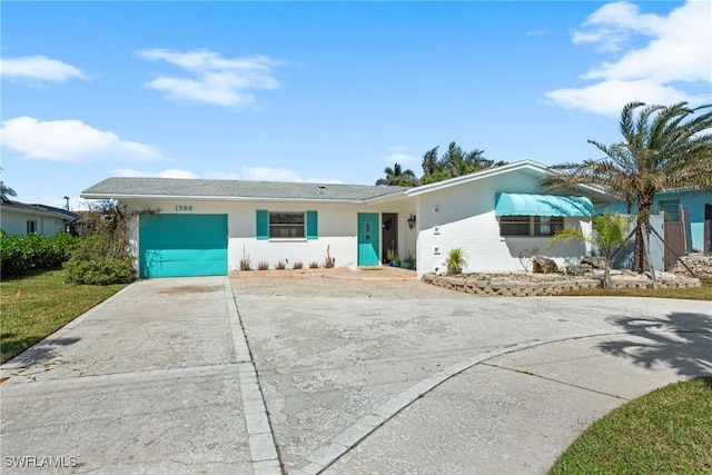 single story home with driveway, an attached garage, and stucco siding