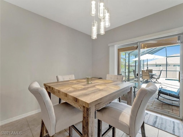 tiled dining room with a notable chandelier