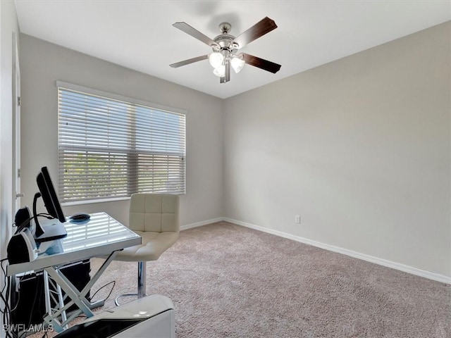 carpeted office space featuring ceiling fan