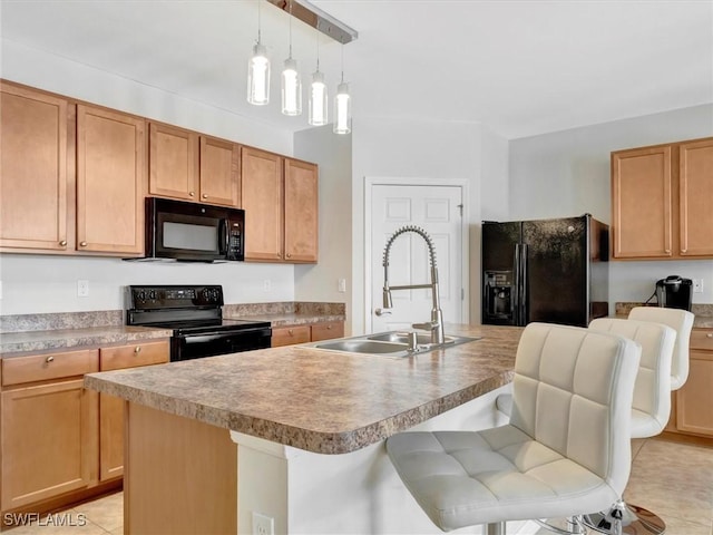 kitchen with a center island with sink, sink, a breakfast bar area, and black appliances