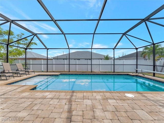 view of pool with a patio and glass enclosure