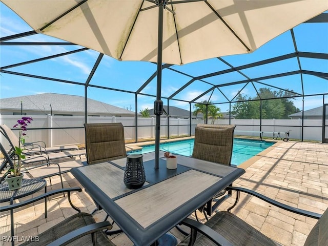 view of patio / terrace with a fenced in pool and glass enclosure