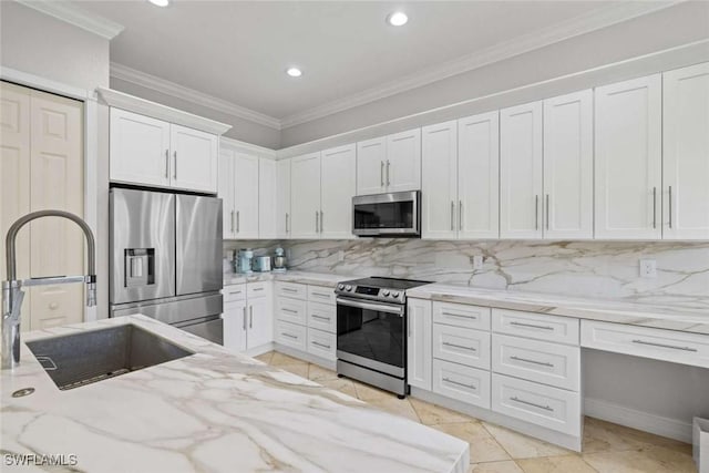 kitchen featuring a sink, white cabinets, appliances with stainless steel finishes, backsplash, and crown molding