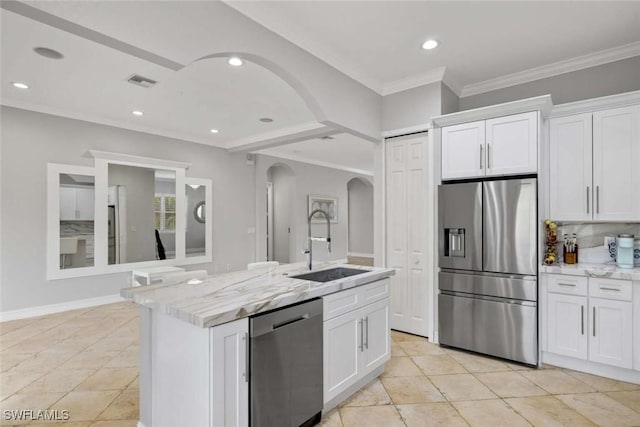 kitchen with arched walkways, stainless steel appliances, visible vents, white cabinetry, and a sink