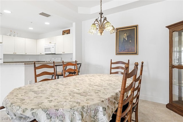 tiled dining space with a notable chandelier