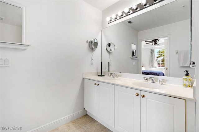 bathroom with tile patterned flooring, vanity, and ceiling fan