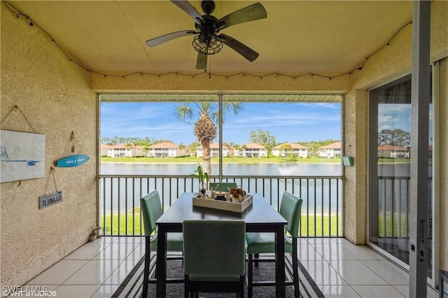 balcony with a water view and ceiling fan