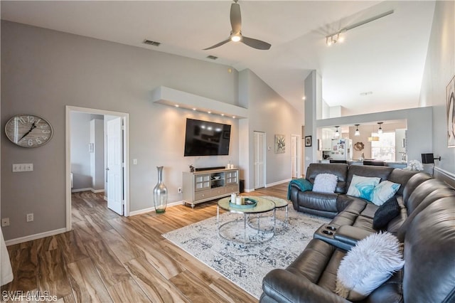 living room featuring light wood-type flooring, high vaulted ceiling, and ceiling fan