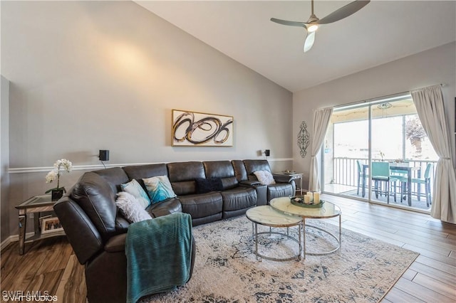 living room featuring hardwood / wood-style floors, high vaulted ceiling, and ceiling fan