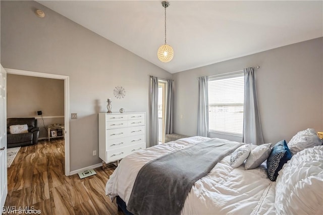 bedroom with lofted ceiling and wood-type flooring