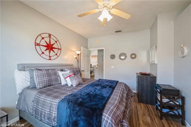 bedroom with ceiling fan and dark hardwood / wood-style flooring