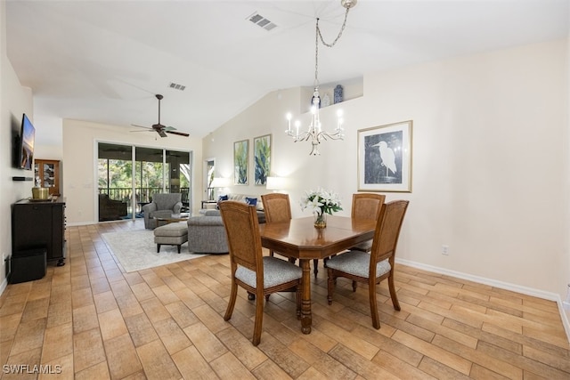 dining space with lofted ceiling, ceiling fan with notable chandelier, and light wood-type flooring