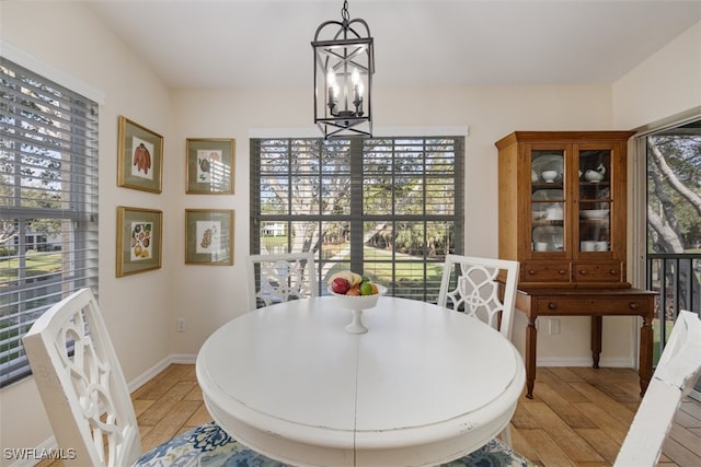 5644 Sandlewood Ct Unit 1903, Naples, FL 34110 - dining room featuring light wood-style floors, a chandelier, and baseboards