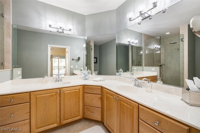 bathroom featuring vanity, tile patterned flooring, and a shower with shower door