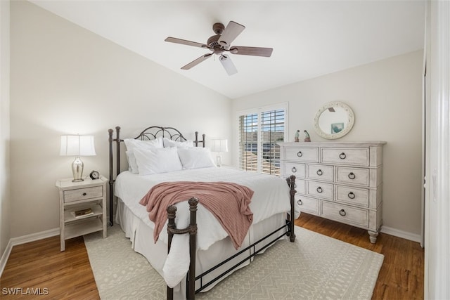 bedroom featuring hardwood / wood-style flooring, lofted ceiling, and ceiling fan