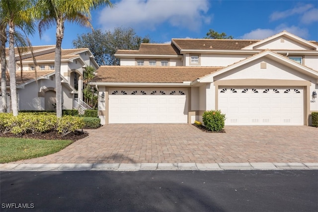 5644 Sandlewood Ct Unit 1903, Naples, FL 34110 - view of front of home with stucco siding, a tiled roof, decorative driveway, and an attached garage