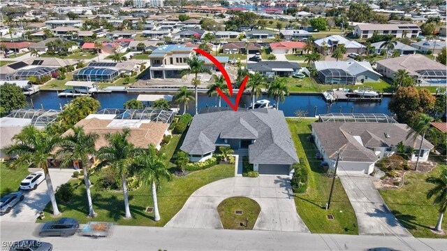 bird's eye view featuring a water view and a residential view