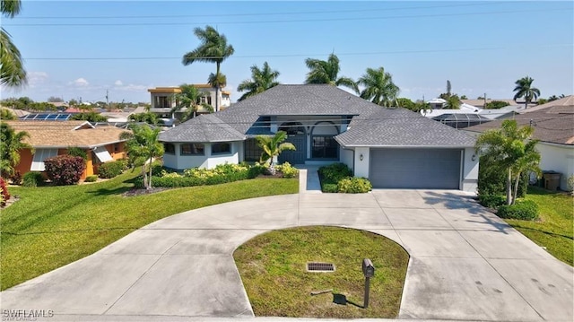 ranch-style house with a garage and a front lawn