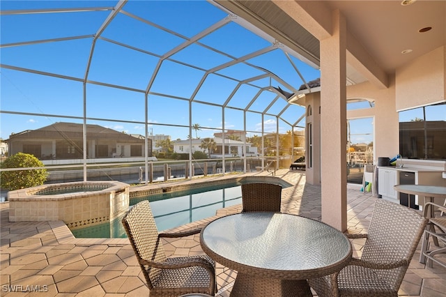 view of patio / terrace featuring a pool with hot tub and glass enclosure