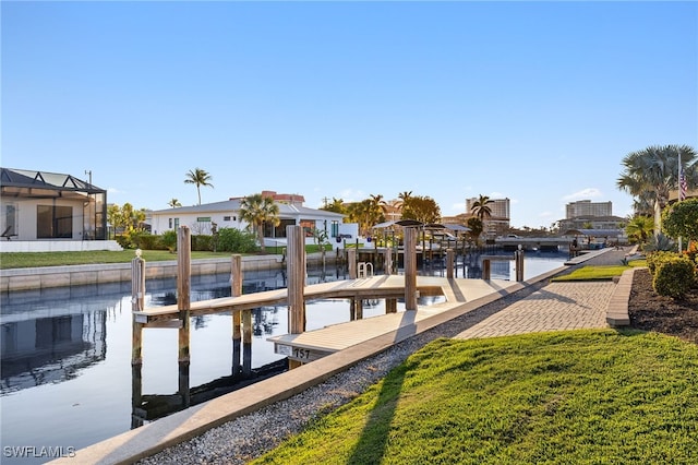 dock area with a water view and a yard