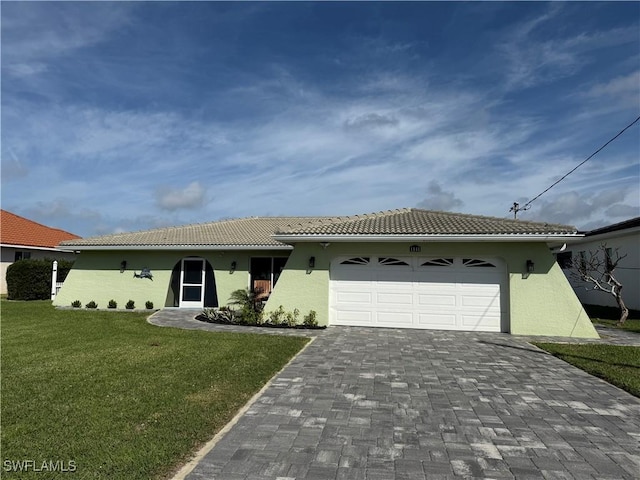 ranch-style home featuring a tiled roof, a front lawn, decorative driveway, and stucco siding