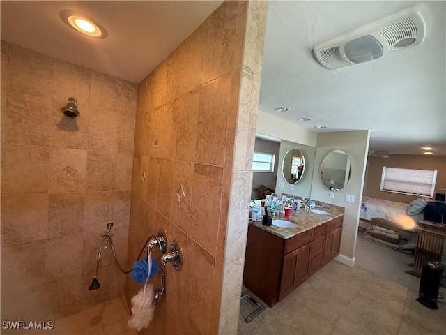full bathroom with a walk in shower, double vanity, a sink, and visible vents