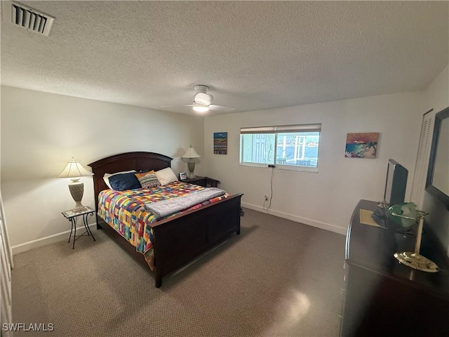 carpeted bedroom featuring baseboards, a textured ceiling, visible vents, and a ceiling fan