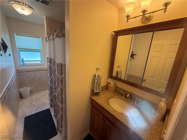 bathroom featuring a shower with curtain, tile patterned flooring, visible vents, and vanity