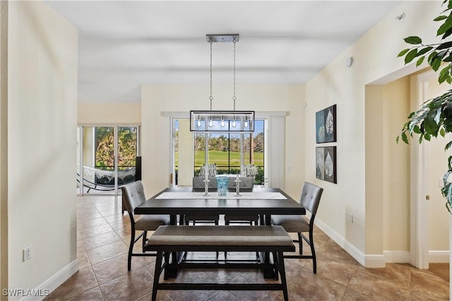 tiled dining room with baseboards