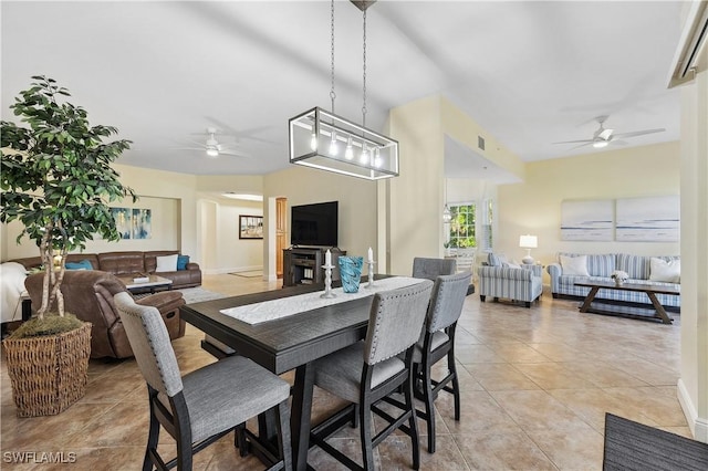 dining space featuring ceiling fan, visible vents, and light tile patterned flooring